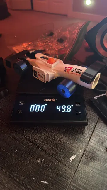 The finished car on a digital scale reading 49.8 grams