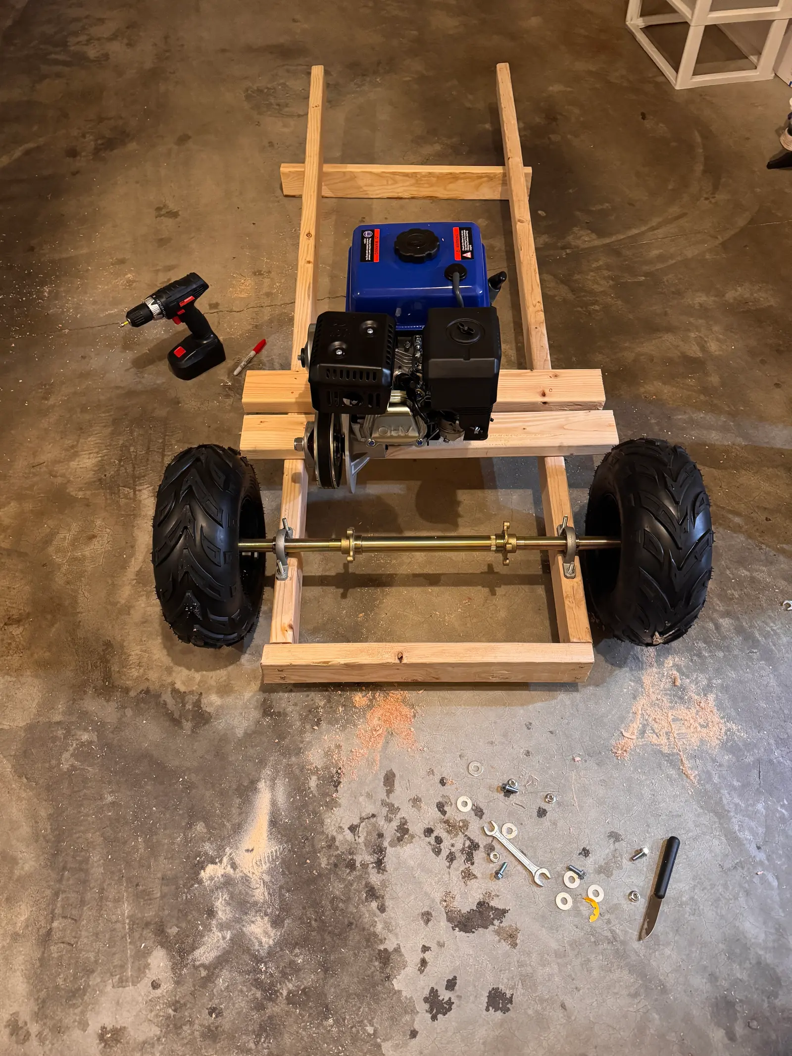 Top-down view of the frame with the engine, rear wheels and axle fitted